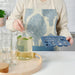 Person wearing an apron holding the IKEA SURSÖT ice cube tray in a kitchen