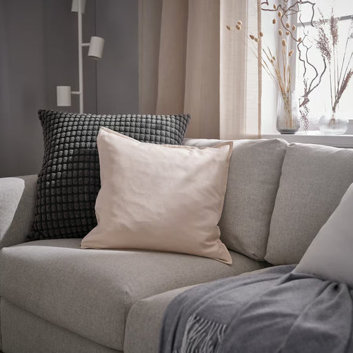 IKEA SVARTPOPPEL anthracite cushion cover styled on a sofa in a living room setting