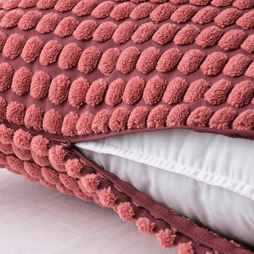 IKEA SVARTPOPPEL light red cushion cover close-up showing textured pile pattern and zip closure