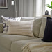 IKEA SVARTPOPPEL off-white cushion cover styled on a sofa with tufted texture visible