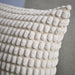Close-up of IKEA SVARTPOPPEL off-white cushion cover heart-shaped textured pattern and stitching detail