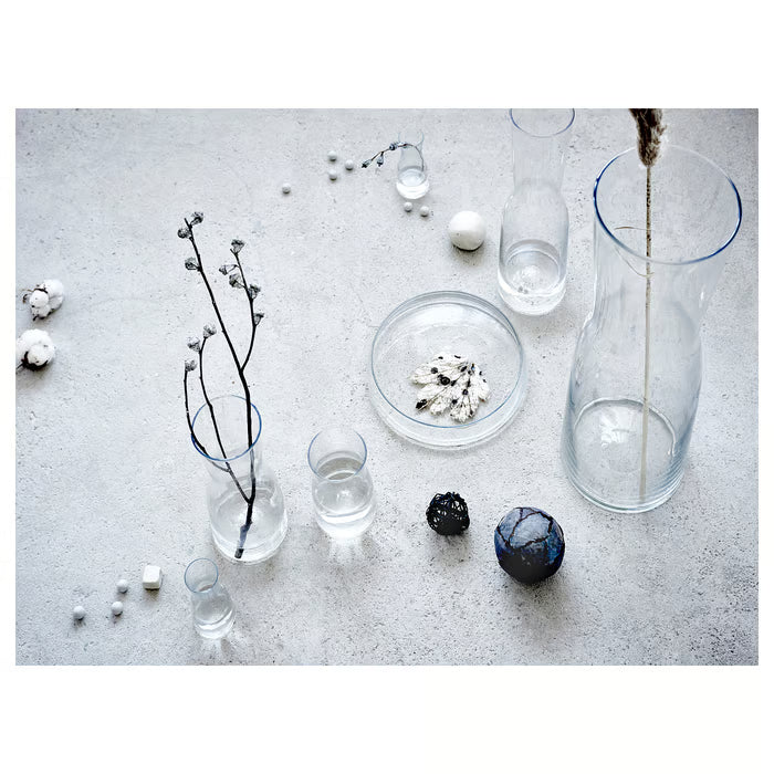 IKEA TIDVATTEN glass vases grouped with twigs and cotton decorations on grey concrete surface