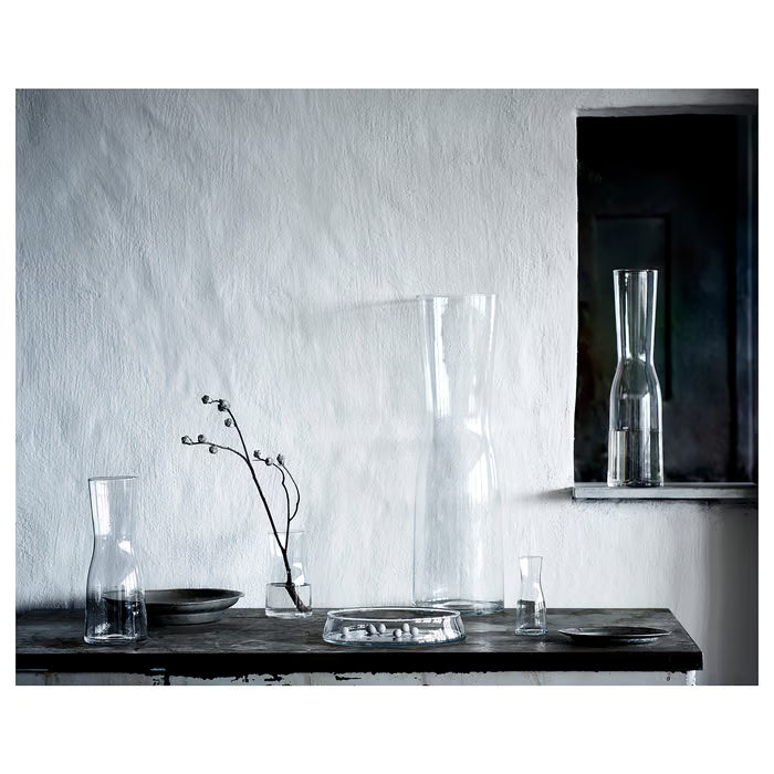 IKEA TIDVATTEN clear glass vase with twig on rustic wooden table against white wall