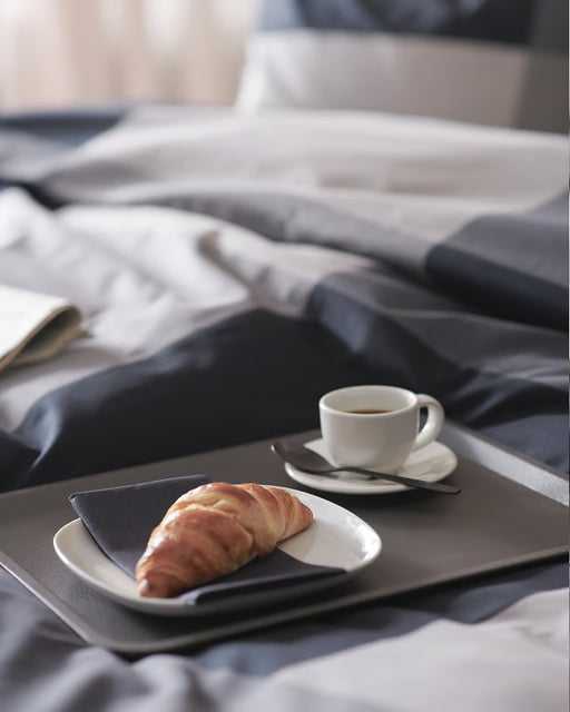 IKEA TILLGÅNG grey tray with angled edges holding a cup and saucer