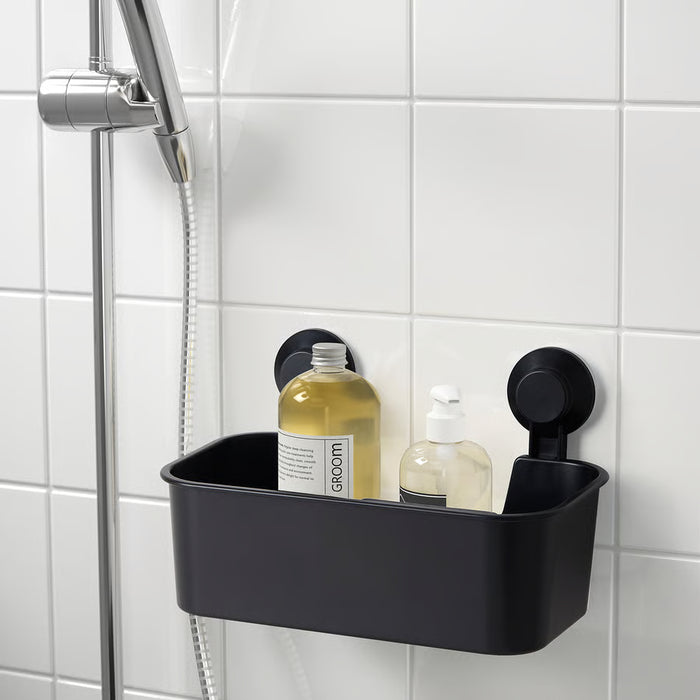 IKEA TISKEN black suction cup basket holding shampoo and soap bottles in shower