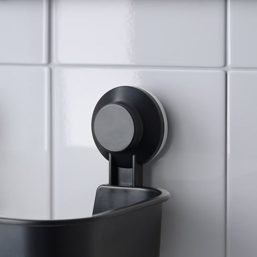 IKEA TISKEN black suction cup basket mounted on white tiled shower wall