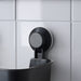 IKEA TISKEN black suction cup basket mounted on white tiled shower wall