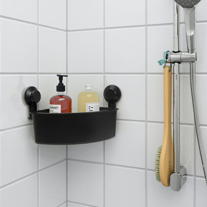  IKEA TISKEN black corner shelf holding shampoo and soap bottles near shower