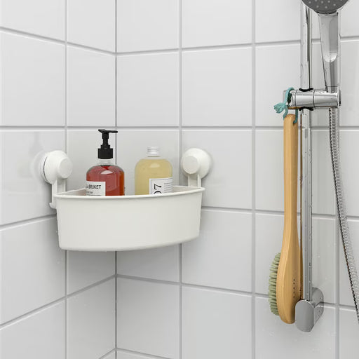 IKEA TISKEN white corner shelf holding soap dispenser and bottles on tiled shower wall