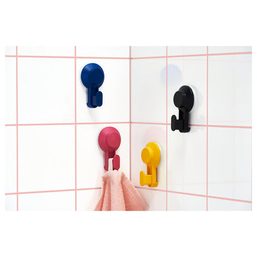IKEA TISKEN mixed colour suction hooks mounted on bathroom tiled wall holding towels