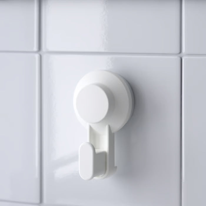 Single IKEA TISKEN white suction hook on white tile wall showing clean minimal design