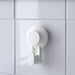 Single IKEA TISKEN white suction hook on white tile wall showing clean minimal design