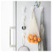 IKEA TISKEN white suction hook in use in bathroom with toiletries hanging on smooth tiled wall