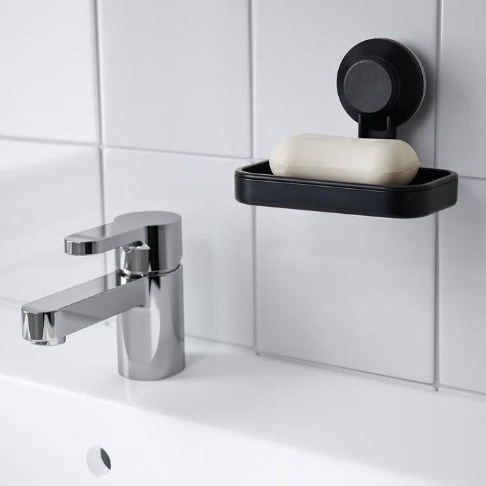 IKEA TISKEN black soap dish on bathroom wall near chrome tap with white soap bar