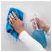 Person wiping tiled bathroom wall with cloth before mounting IKEA TISKEN suction soap dish