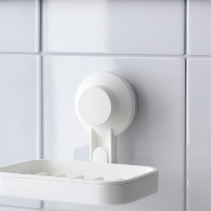 IKEA TISKEN white soap dish holding beige soap bar on tiled wall near chrome tap