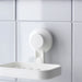 IKEA TISKEN white soap dish holding beige soap bar on tiled wall near chrome tap