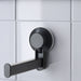 IKEA TISKEN black toilet roll holder stuck on smooth bathroom tiles with suction cup, no drilling needed