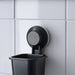 IKEA TISKEN black toothbrush holder mounted on tiled bathroom wall with suction cup