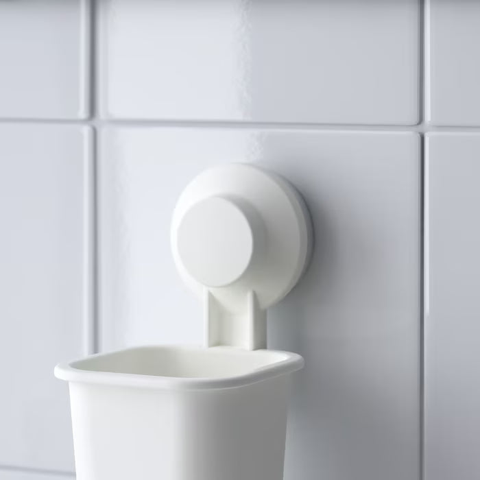IKEA TISKEN white suction cup holder in use in small bathroom with multiple toothbrushes stored