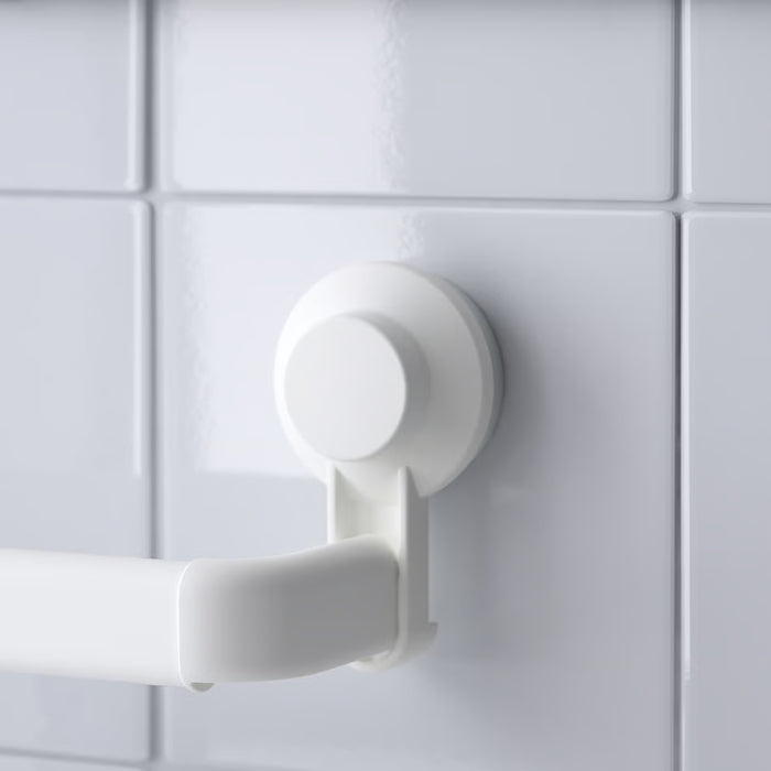 Close-up of IKEA TISKEN white suction cup mounted on tiled wall showing secure no-damage grip