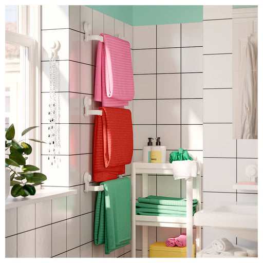 IKEA TISKEN white towel rack mounted on tiled bathroom wall holding folded towels