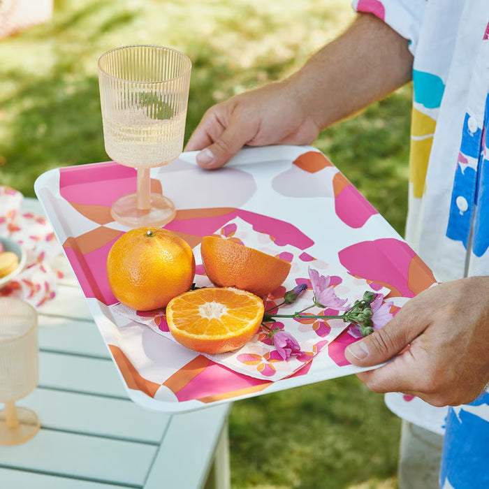 IKEA TOFSAND pink napkin styled on outdoor table with fruit tray and wine glasses