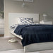 IKEA TRATTVIVA bedspread, black-blue, 150x250 cm, draped over a bed in a modern bedroom
 10584445