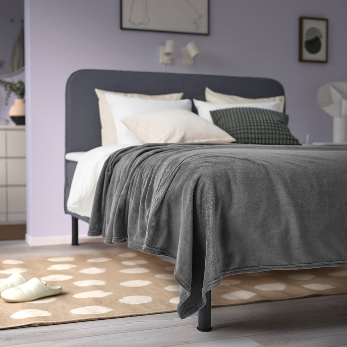 IKEA TRATTVIVA dark grey bedspread covering large bed with pillows cosy setup