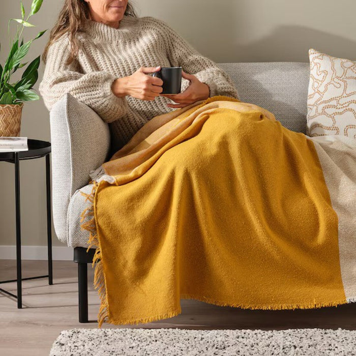 "Warm and inviting dark yellow/off-white throw blanket: IKEA UGGLEFLY"