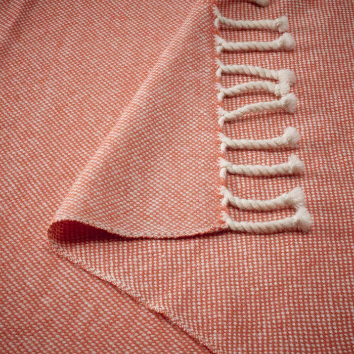 "Close-up of the blush IKEA ULLTISTEL throw blanket, focusing on the rich, soft wool texture."