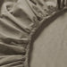 Close-up of IKEA ULLVIDE grey-beige fitted sheet showing tight percale weave and elastic edge detail