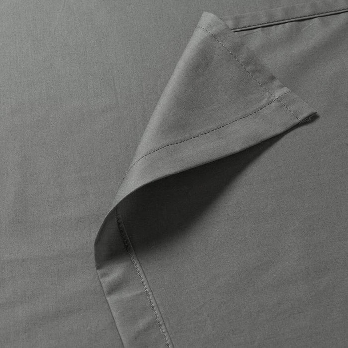 Close-up of gray fabric with a focus on texture and stitching detail.