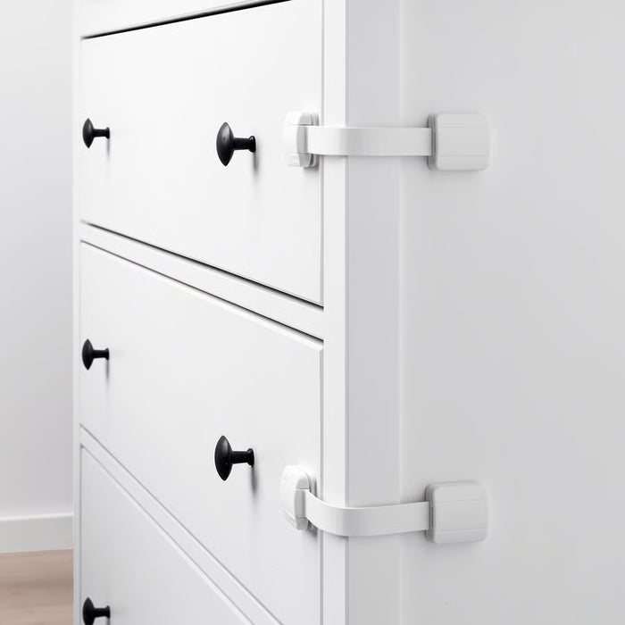 IKEA UNDVIKA white child safety latches fitted on white furniture drawers and cabinet door with black handles