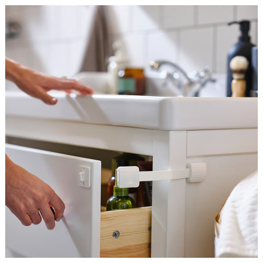 IKEA UNDVIKA white multi latch installed on a drawer showing how the strap wraps around the edge