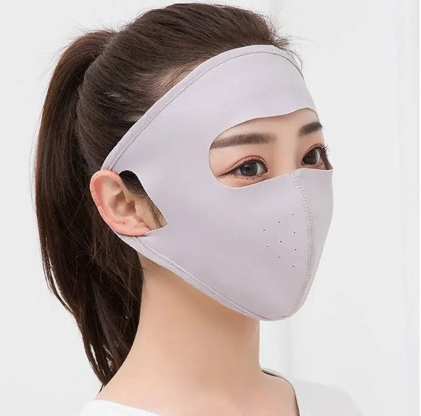 Woman wearing a gray face mask with a white background