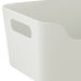 Close-up of IKEA UPPDATERA white storage box showing smooth easy-clean surface and grip handles
