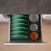 Kitchen drawer with green plates and bowls neatly separated using IKEA UPPDATERA peg system