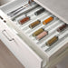 IKEA UPPDATERA anti-slip spice rack keeping spice jars securely in place inside a kitchen drawe