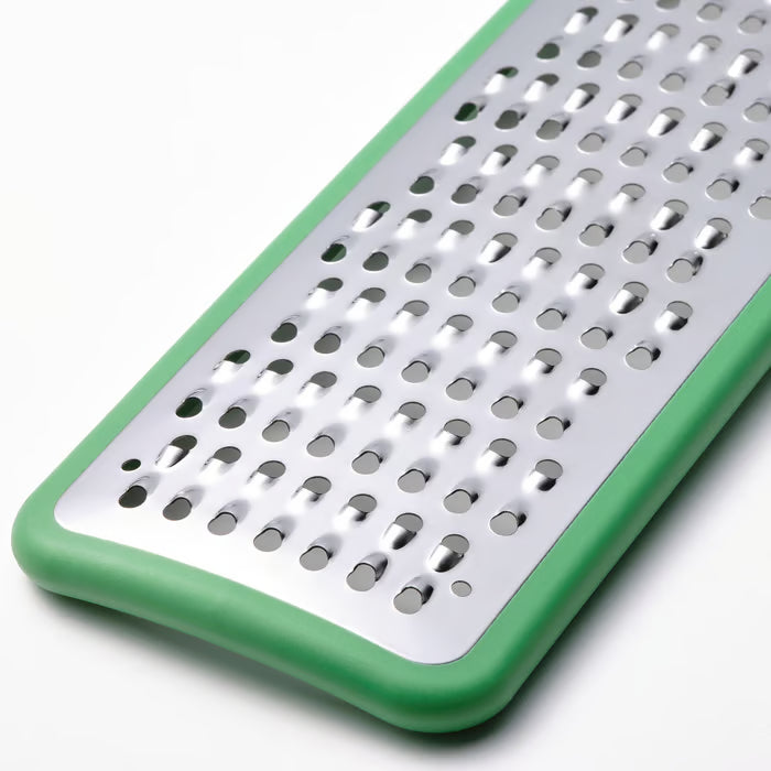 Close-up of the bright green handle on the IKEA UPPFYLLD grater with hanging storage hole
