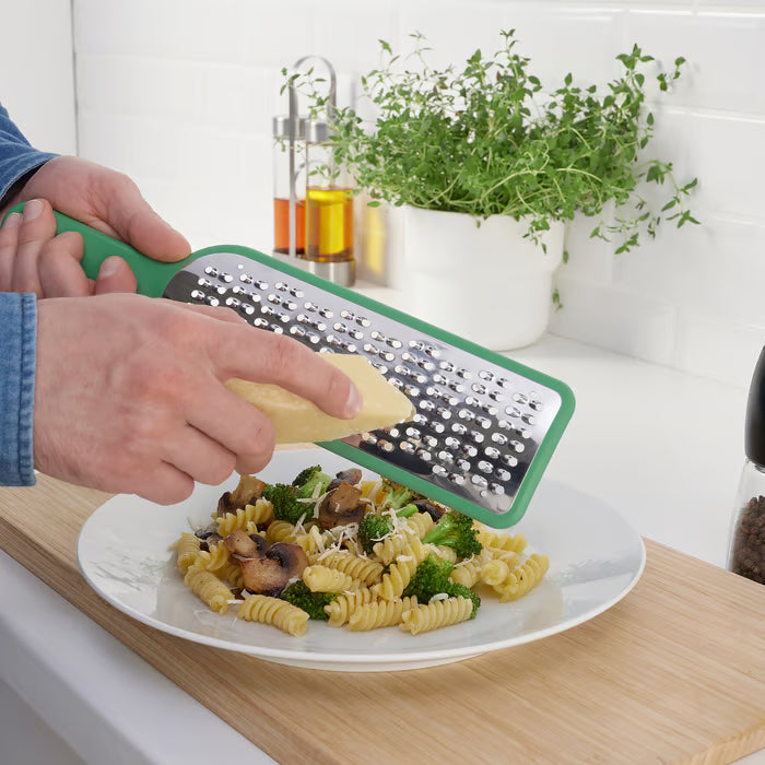 IKEA UPPFYLLD green handheld grater showing two-way grating blades for efficient shredding