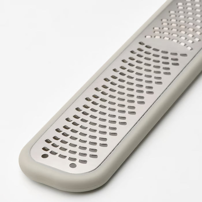 Close-up of IKEA UPPFYLLD grater handle featuring a hole for easy hanging storage