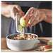 IKEA UPPFYLLD handheld grater with protective cover being removed for use in kitchen