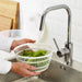  Hands rinsing lettuce in IKEA UPPFYLLD salad spinner basket under kitchen tap