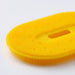 Person using IKEA UPPFYLLD yellow vegetable scrubber to clean potatoes on kitchen counter showing dual scrubbing sides