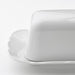 IKEA UPPLAGA white porcelain butter dish with ruffled edge on white surface close view