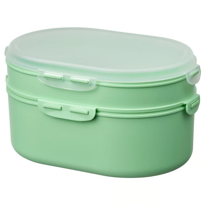 IKEA UTBJUDA stackable lunch box in light green with two-tier design for dry food storage.


