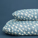 Two IKEA UTSÅDD blue and white patterned pet cushions stacked, showing cover fabric and fill thickness