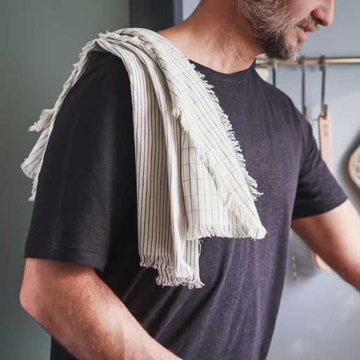  IKEA VÄLVÅRDAD white blue striped cotton linen tea towel draped over shoulder lifestyle view