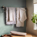  IKEA VÄLVÅRDAD tea towels with stripe pattern and fringe hanging on wall hooks kitchen setting